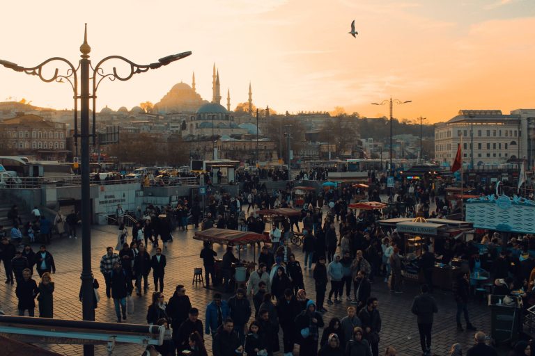 Busy street market scene in Istanbul with crowd at sunset, showcasing vibrant city life and architecture. — Coronavirus disea